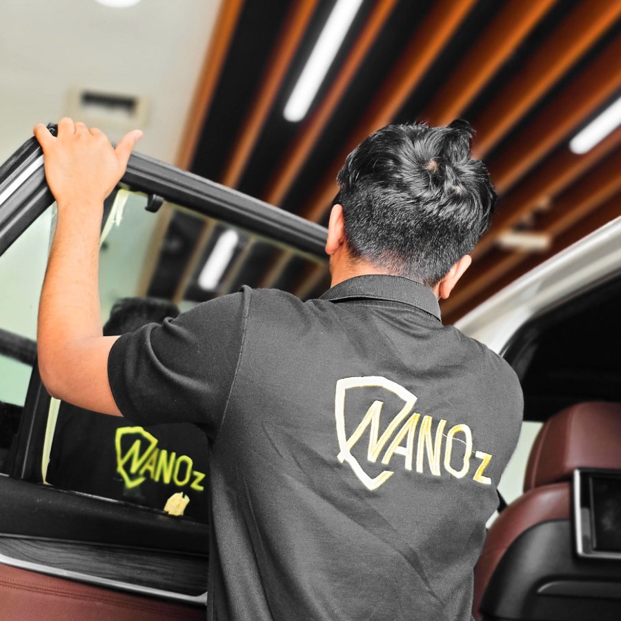 A Nanoz technician fitting tint in the Muwaileh studio