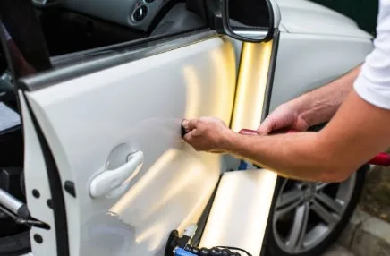 Paintless dent repair on a car panel